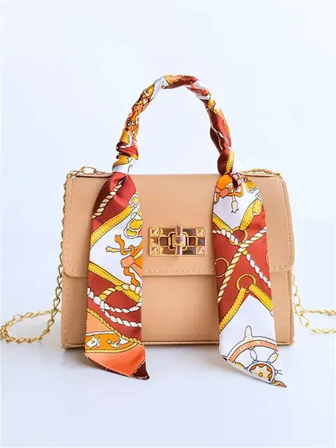 Brown Leather Handbag with Gold Accents and Silk Scarf – Chic and Timeless Accessory