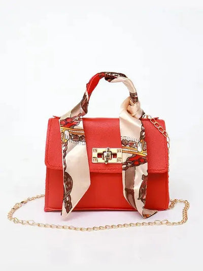 Brown Leather Handbag with Gold Accents and Silk Scarf – Chic and Timeless Accessory